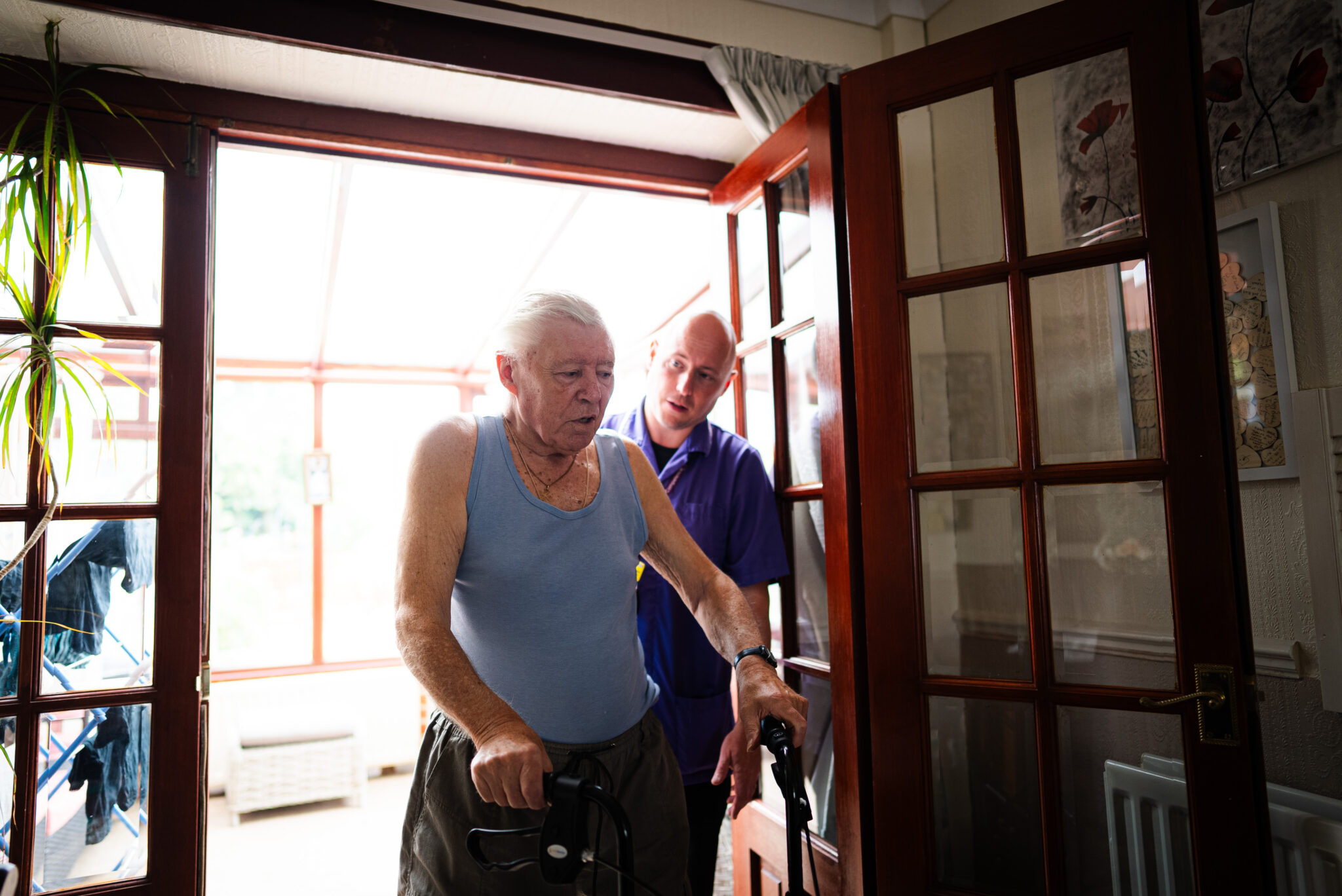 Community Matron Community Matron helping patient to walk - Bromley Healthcare