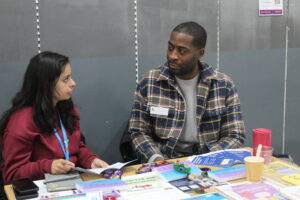 two people sitting at a table talking